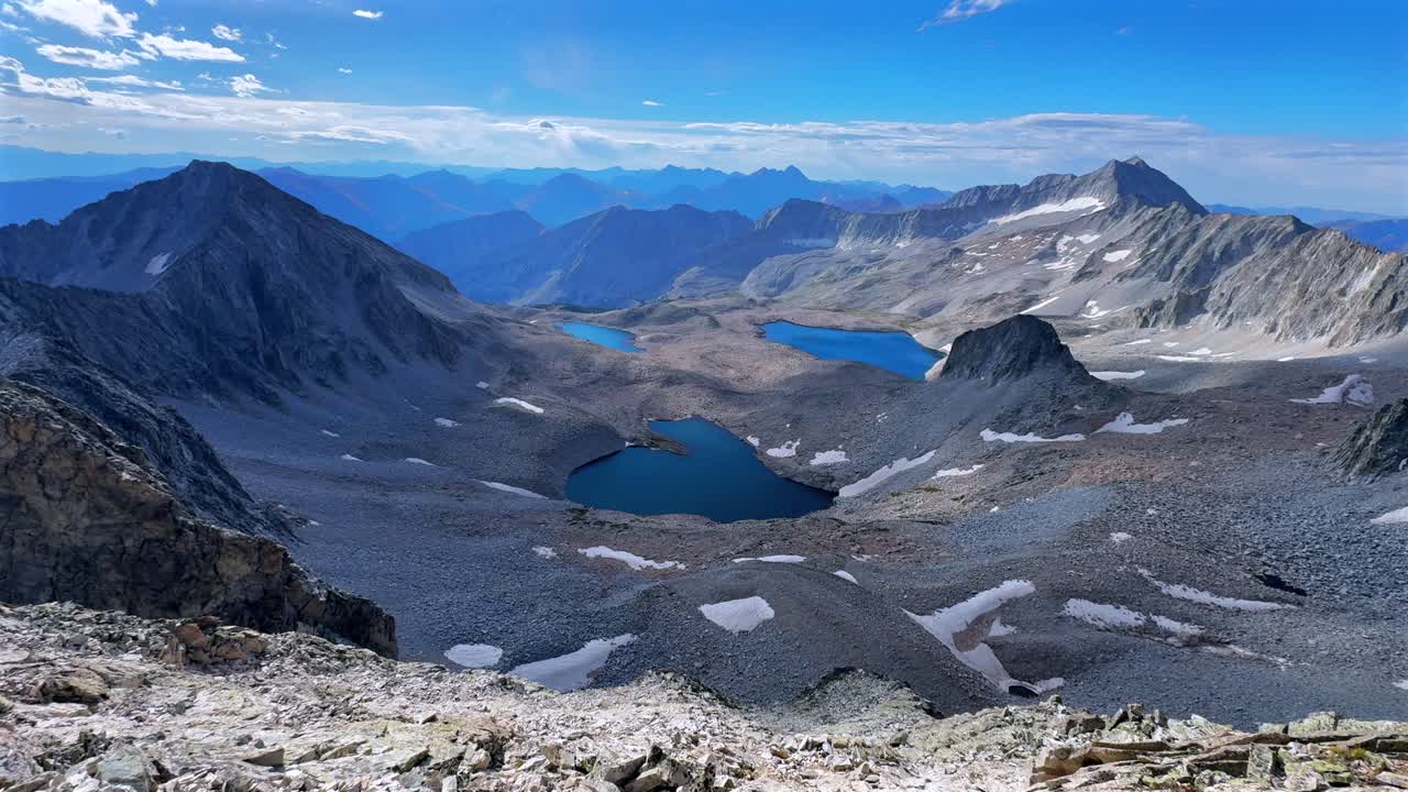 Capitol Peak 14er Wilderness high alpine elevation Rocky Mountains Colorado aerial drone Maroon Bells Peaks Mount Snowmass Knifes Edge Ridge Pierre Lakes summer early morning blue sky cloudy static