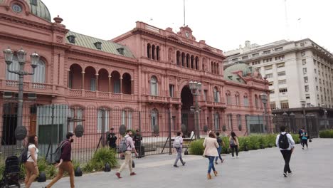pov walking at the casa rosada pink government house, plaza landmark with local people