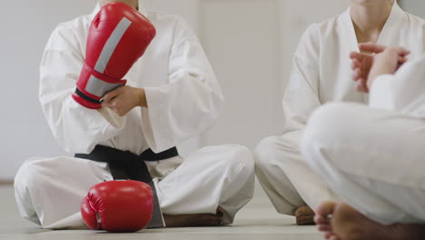 woman putting fighting gloves on