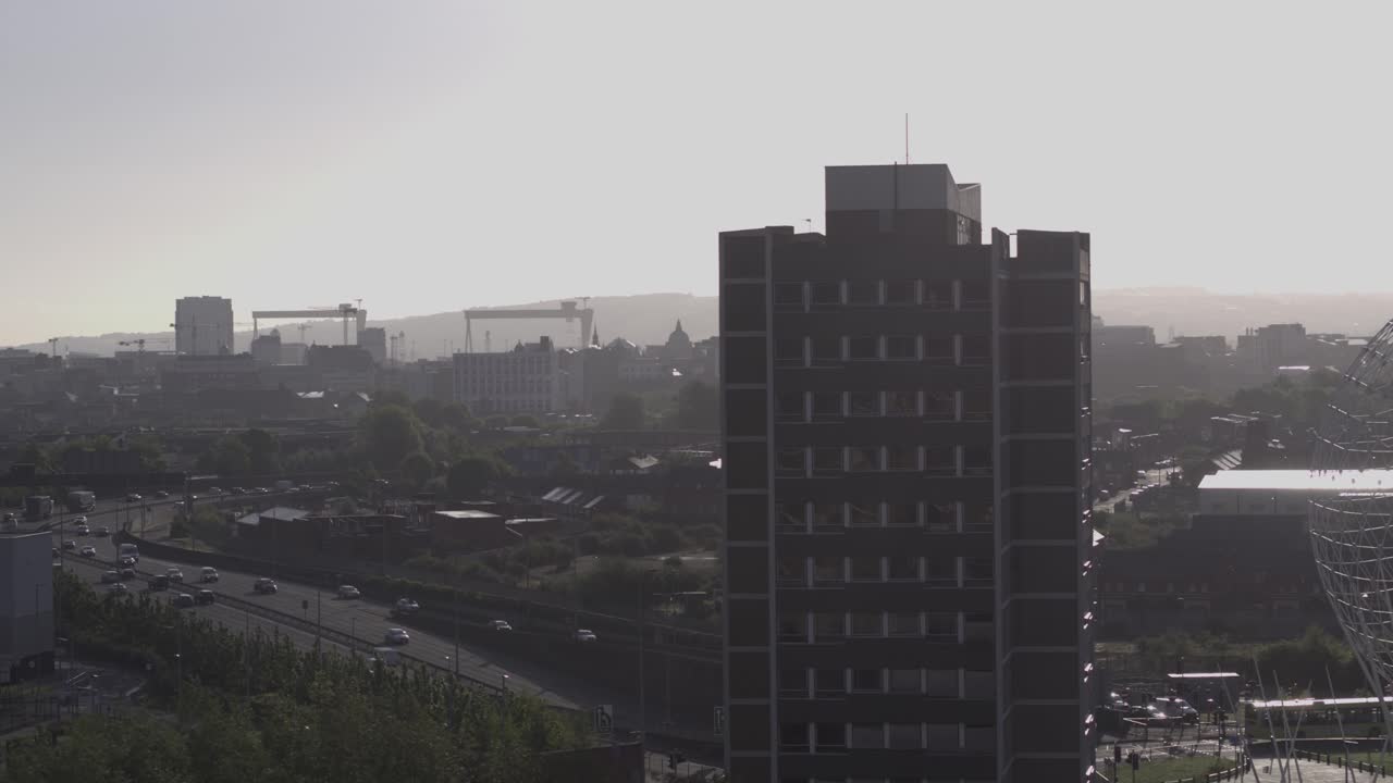 Aerial flyover of Belfast and the Rise Sculpture near the Falls Road and Westlink Motorway