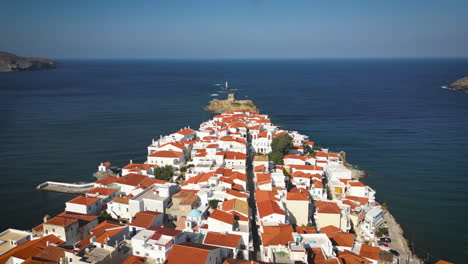 An-aerial-view-of-a-picturesque-coastal-town-with-white-houses-and-red-roofs-extending-into-the-deep-blue-sea