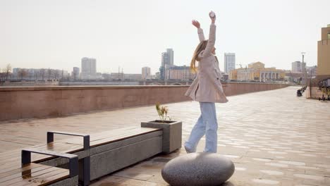 great news - a woman with a smartphone in her hand is jumping with happiness. she got good news - she was hired