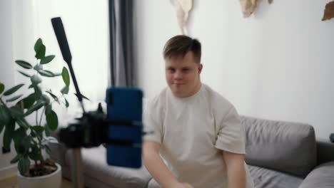 young downs syndrome guy dancing in front mobile camera at home