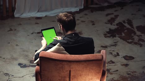 man using tablet in a room