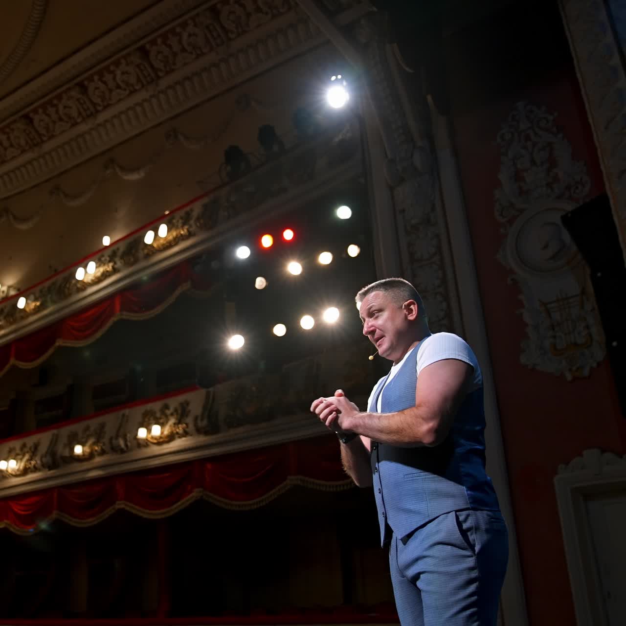 Young actor performing a monologue in a theater. Showman