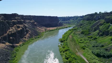 a 4k fly-over drone shot of perrine bridge, a 1,500 foot long bridge, spanning over the snake river in twin falls, idaho