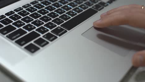 Hand typing on laptop keyboard, personal computer use for work at office or home