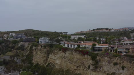 A-beautiful-aerial-drone-shot,-flying-along-the-cliffs-at-the-coast,-Dana-Point---Orange-County---California