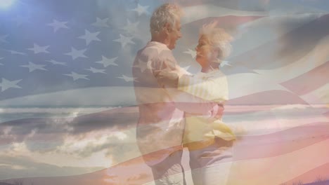 Animation-of-happy-senior-caucasian-couple-dancing-on-beach-over-flag-of-united-states-of-america
