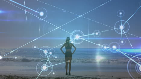 animation of networks of connections over caucasian woman praciticing yoga on beach