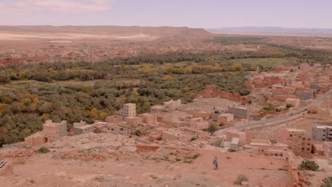 wide establishing shot sand coloured buildings of ouarzazate blend into the mountainous sandy background