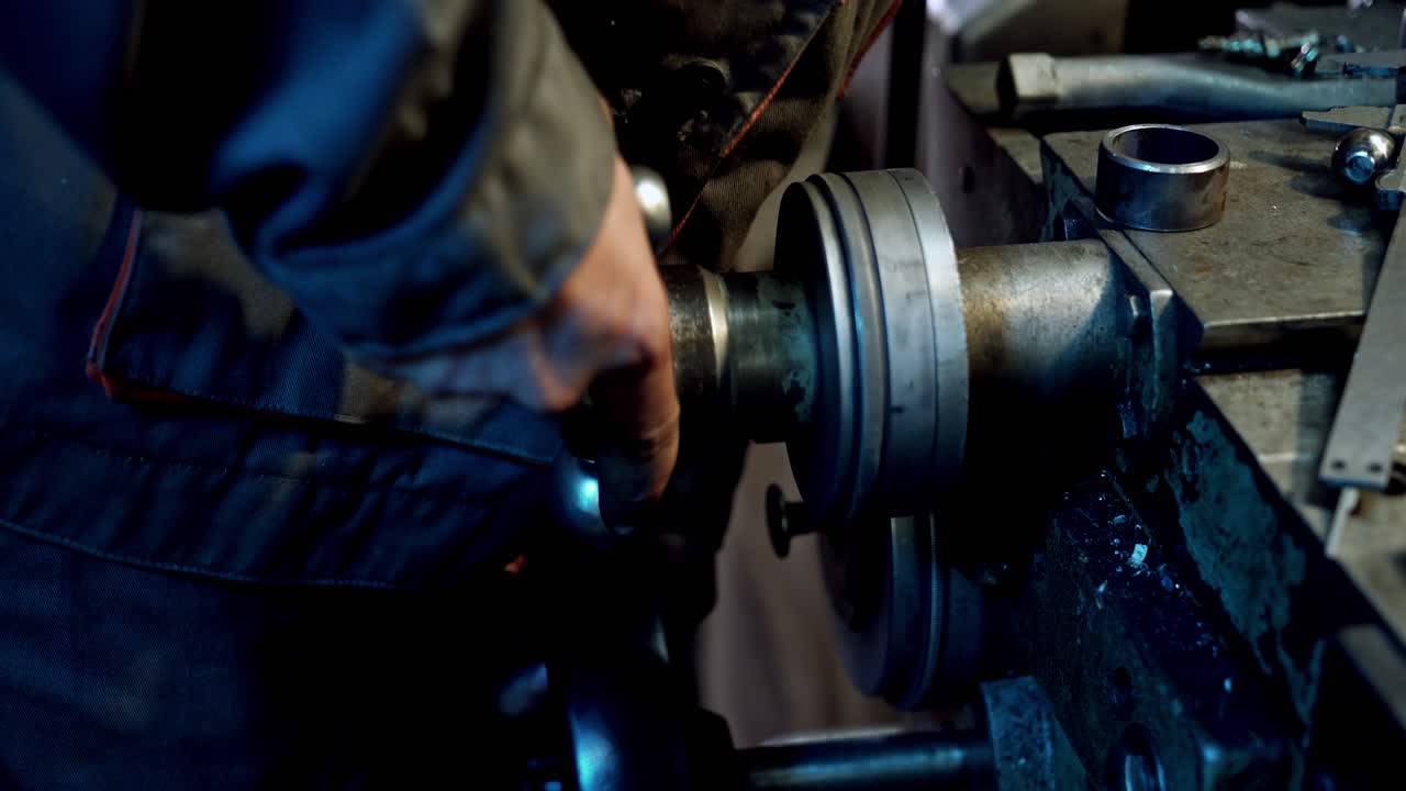 Industry manufacturing metalwork. Close up of hand heavy industrial worker is working on metal work factory process by performing mechanical turning operation at machine