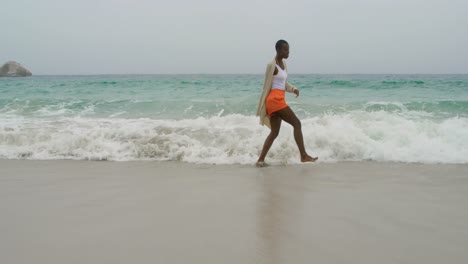 Young-African-american-woman-dancing-on-the-beach-4k