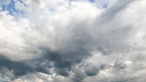 Grey dull cloudscape moving in the sky. Stormy clouds shaded the horizon. Low angle view. Timelapse.