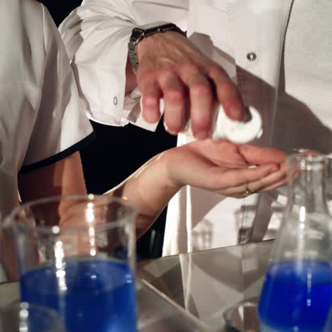 two technicians are performing tests with chemicals and liquids in test tubes at the hospital. experiments in a chemistry lab. close-up