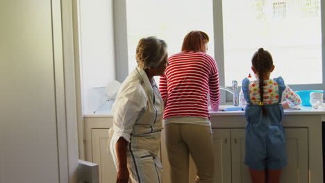 family standing in kitchen at home 4k