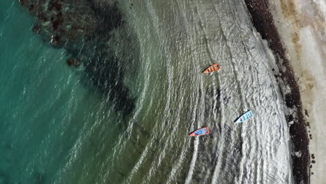 aerial - boats on monte rio beach, azua, dominican republic, top down forward