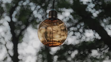 Shallow-Focus-Of-yellow-light-bulb-in-a-camp-ground