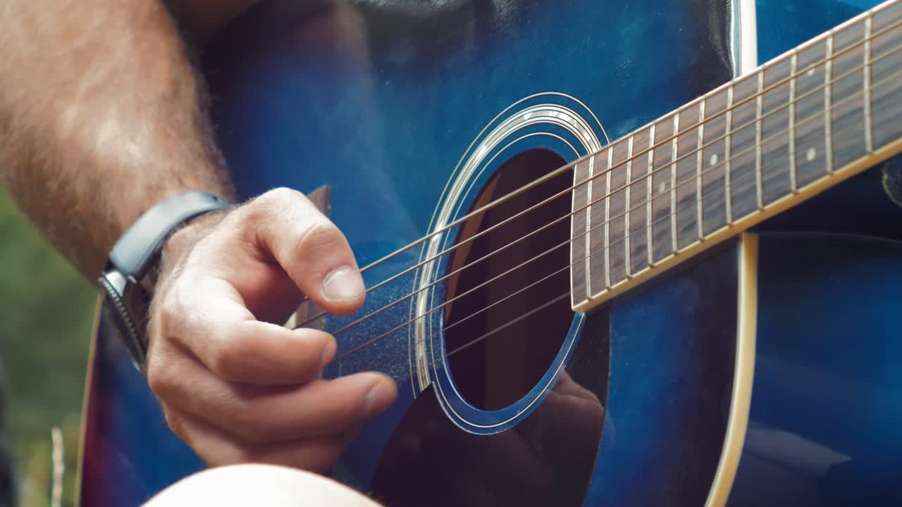 Guy playing the guitar fingertip style