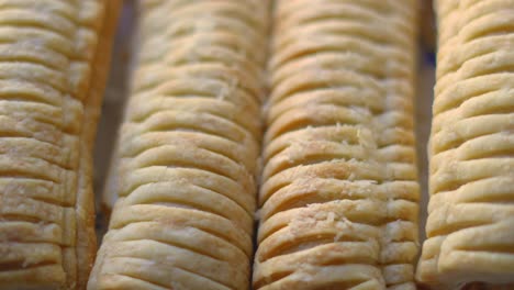 overview of sausage rolls on plate after baking. delicious traditional english fresh bakery product. british snack cuisine. pork meat wrapped in puff pastry.