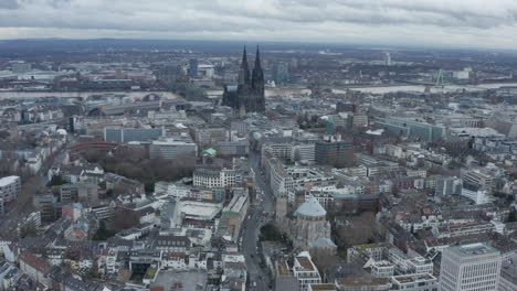 Aerial-footage-of-large-city-with-wide-river-and-majestic-gothic-cathedral.-Tilt-down-on-St-Gereon-church.--Cologne,-Germany