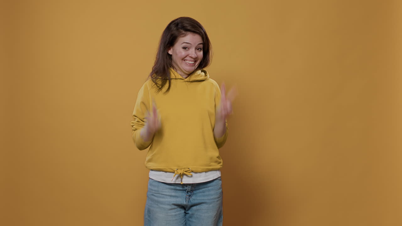 Woman in Yellow Hoodie Giving Peace Sign