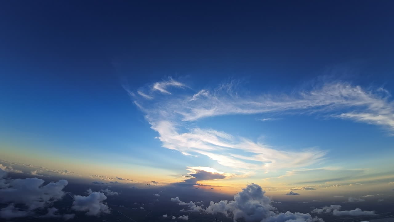 Beautiful blue sky with light clouds of unusual shape. Footage from FPV drone over the cumulus clouds high above the ground.