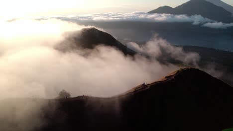 dense clouds canopied mount batur volcano on the island of bali, indonesia