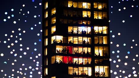 illuminated skyscraper at night with people