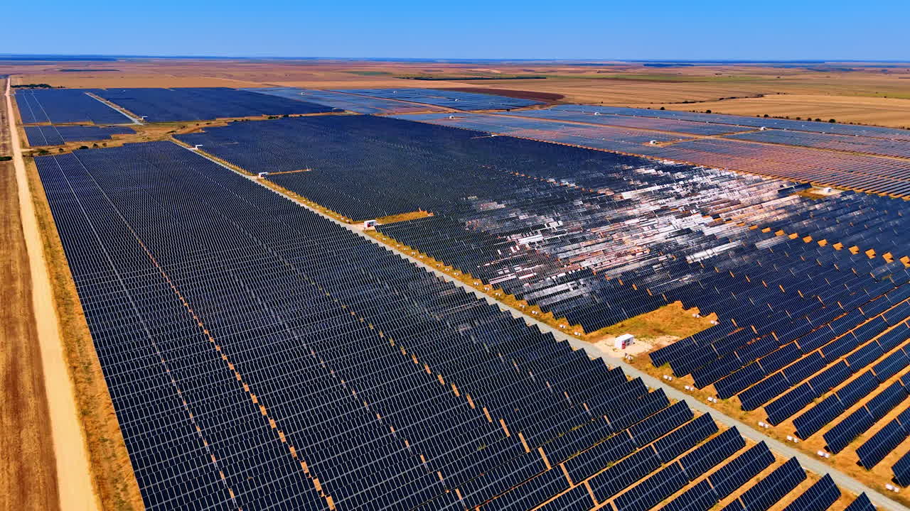 Solar panels in energy field. Solar panels cover a large area under clear blue skies, showcasing a commitment to renewable energy solutions
