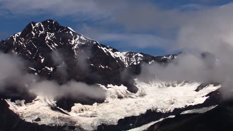 scattered clouds over the glacier and the mountains in glacier bay national park, alaska