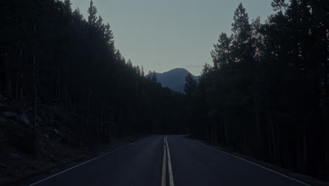 drive on a woodsy mountain road through the rockies