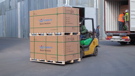 Forklift Loading Solar Panels into Container