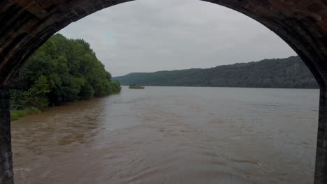 flying under a train bridge in lancaster, pennsylvania - cold color grading