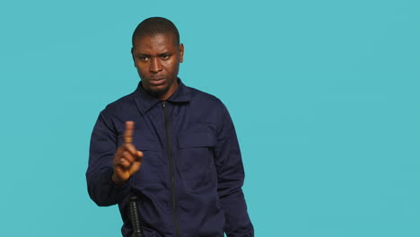 portrait of security agent doing no gesturing with finger, refusing entry