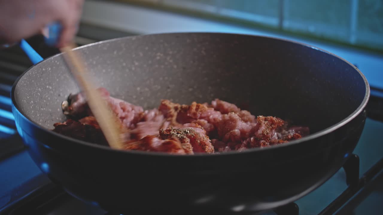Seasoned raw meat in a wok, close up view