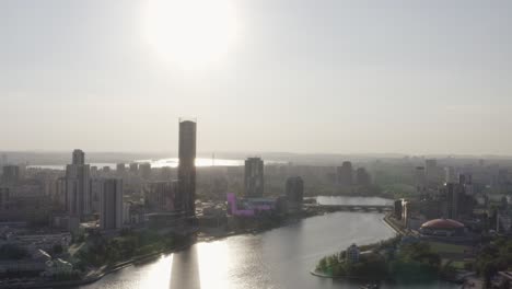 aerial view of city skyline with river and buildings