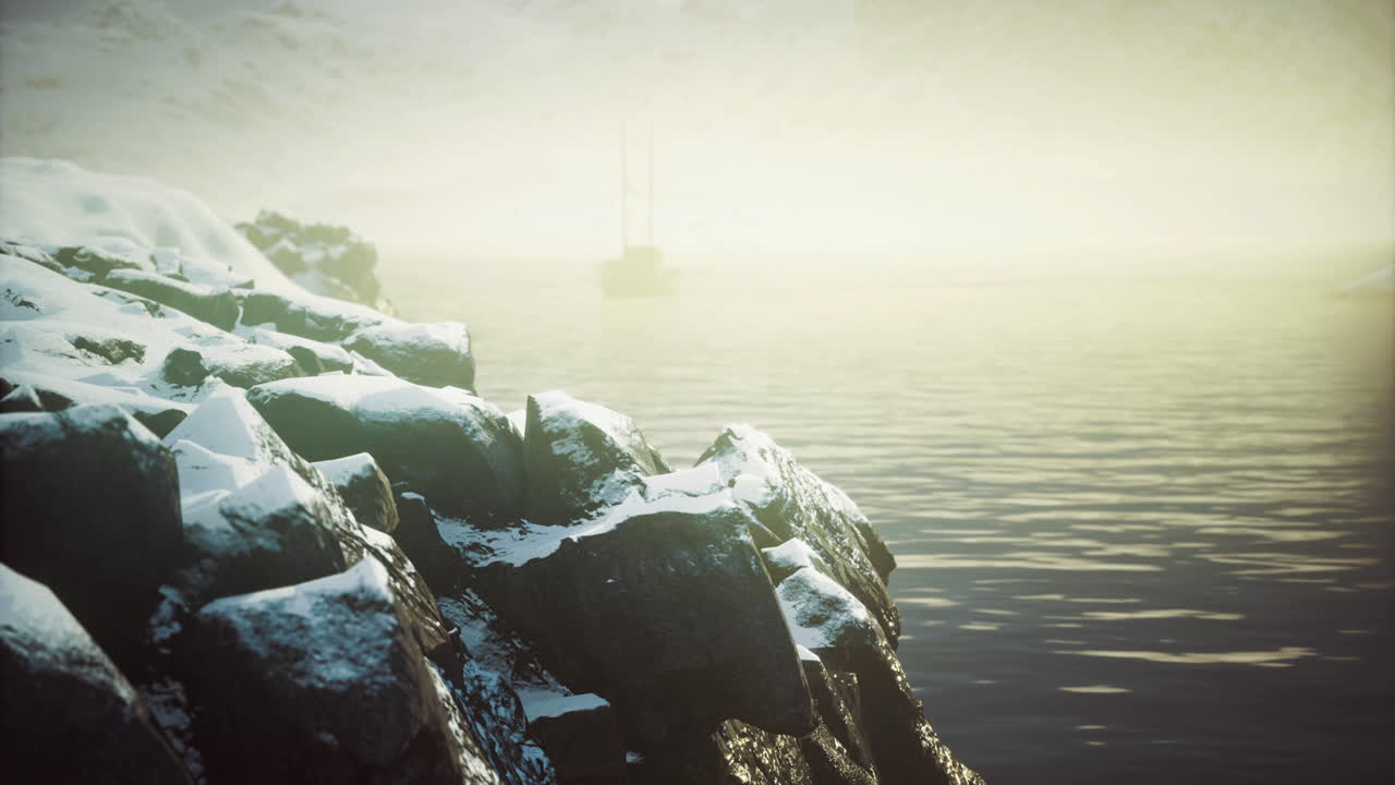 Calm waters reflect soft light against rocky shoreline in serene landscape