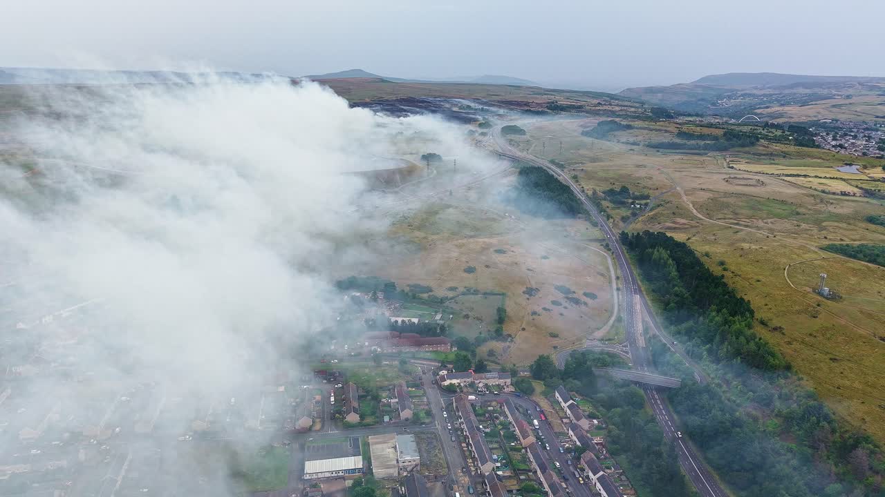 Aerial drone view of thick smoke from a moorland grass fire in the Welsh Valleys, UK