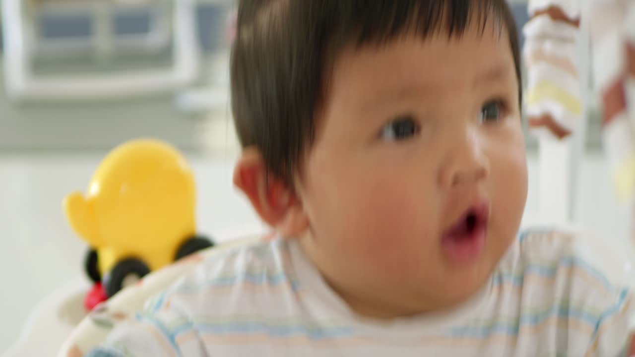 A heartwarming scene of a baby girl receiving loving care during playtime at home.