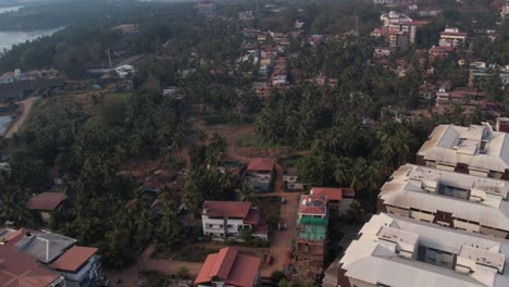 aerial footage of trees covering the buildings in mangalore city