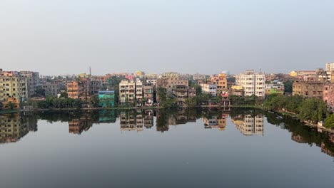 aerial shot of panorama view of apartments near a pond in kolkata india