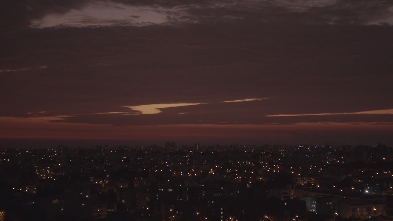 Lima cityscape Darkening after sun down and light turning on.