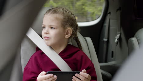 girl with phone in the car