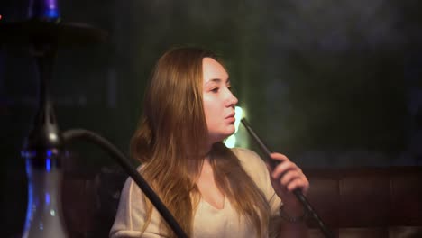 woman smoking hookah in a lounge