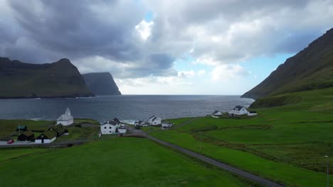 vidareidi village in a valley between mountains and the ocean