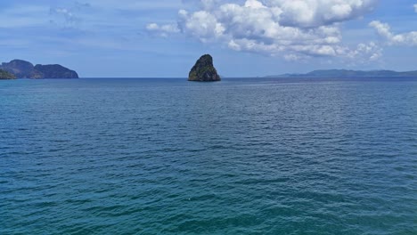 Drone-footage-of-turquoise-water-with-a-small-steep-island-near-Palawan-in-the-Philippines