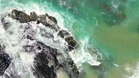 Looking-down-at-the-rocks-next-to-Cudgen-Creek-at-Kingscliff-in-New-South-Wales-in-Australia