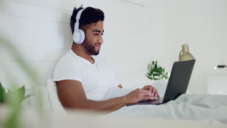 Movie,-laughing-and-man-in-bed-with-a-laptop