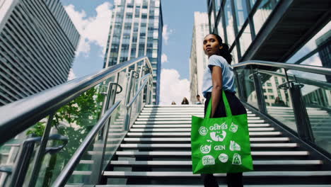 woman with reusable green bag ascends stairs in modern cityscape